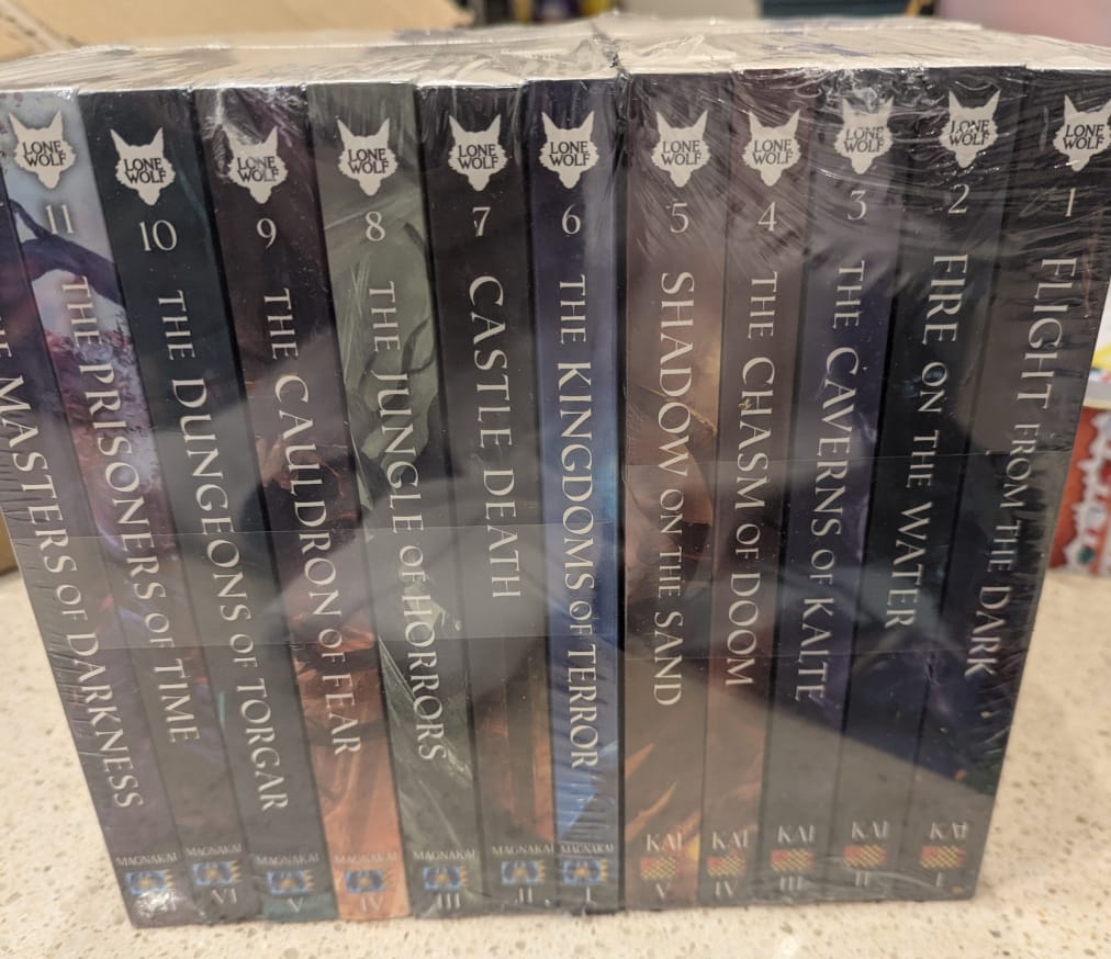 Shrink-wrapped copies of the first twelve Lone Wolf gamebooks, inexplicably ordered left-to-right 12 to 1.