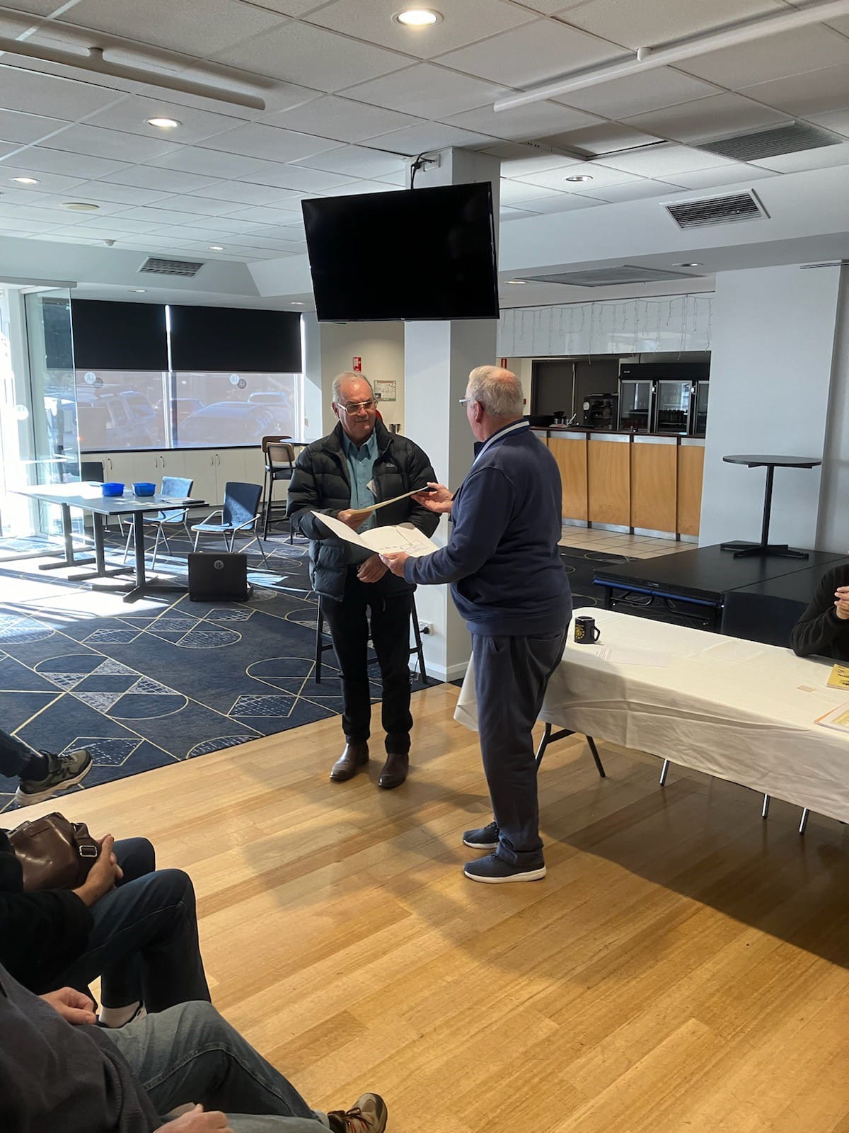 Mr McLaren presenting Neil Munday with his certificate of membership and badge.