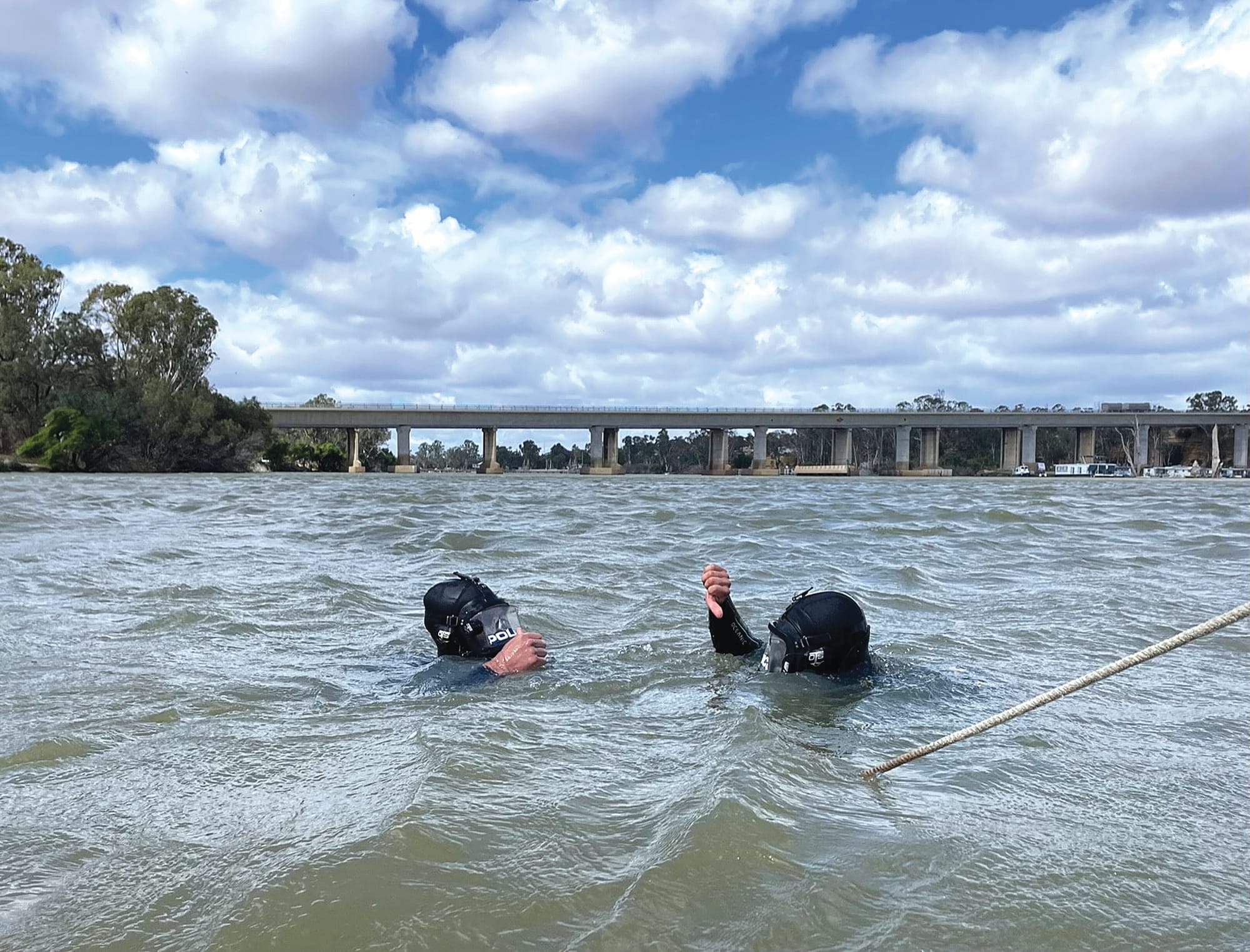 Police officers dive into the Riverland
