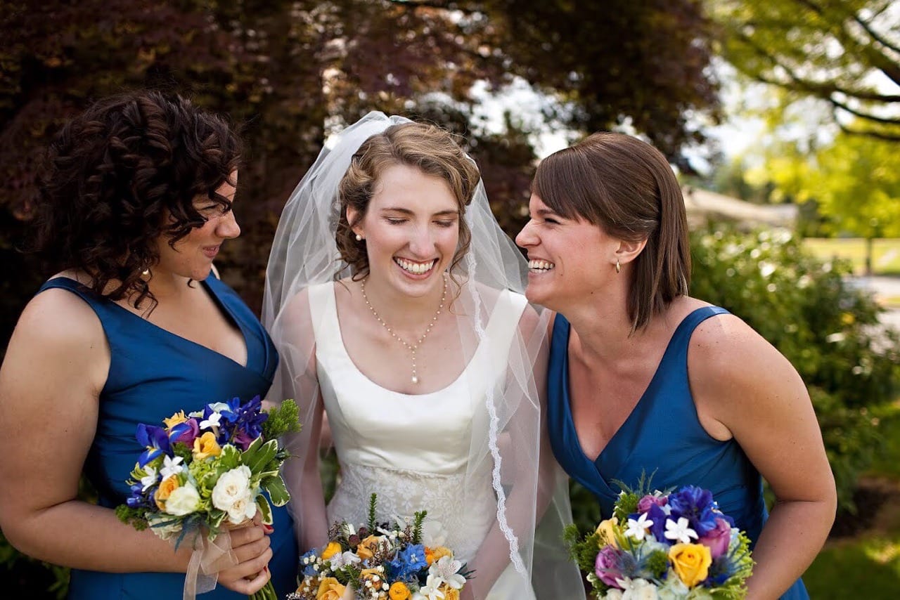 A bride and two bridesmaids laughing