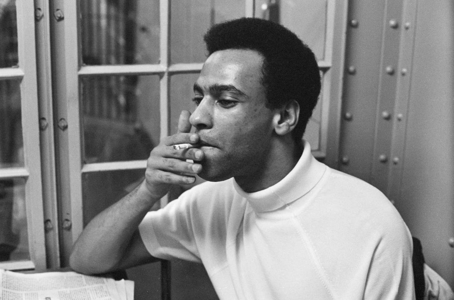 Huey P. Newton smoking a cigarette