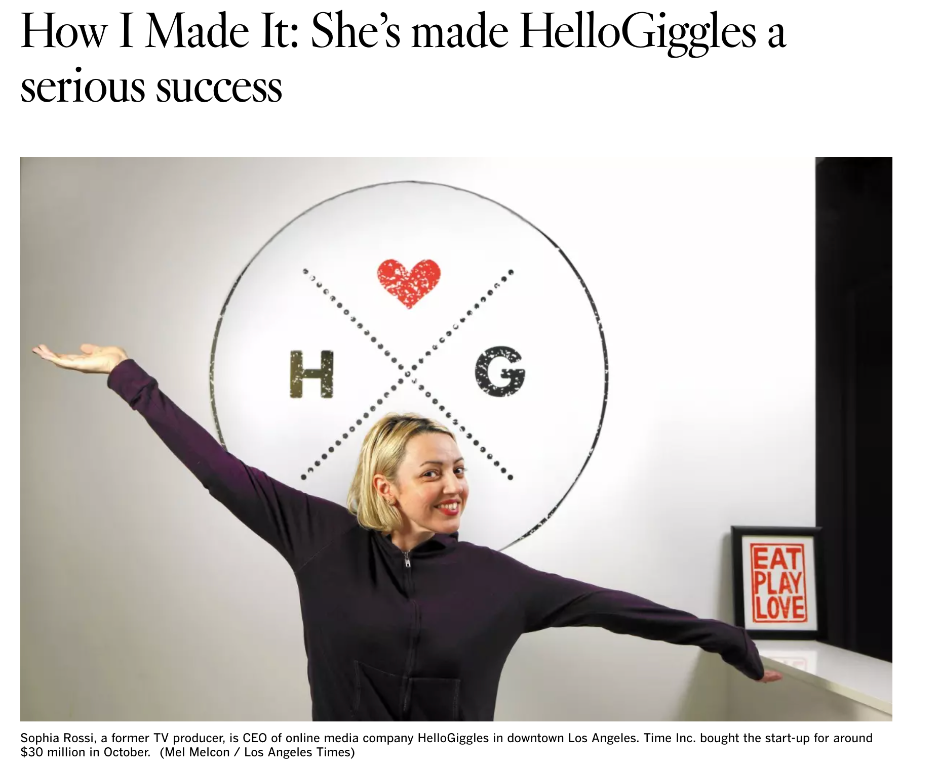 A screenshot of an LA Times article of Sophia Rossi in front of the HelloGiggles logo in her office