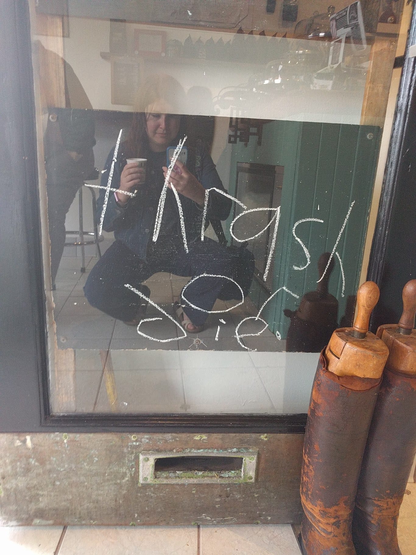 A blackboard sign reading "thrash or die"