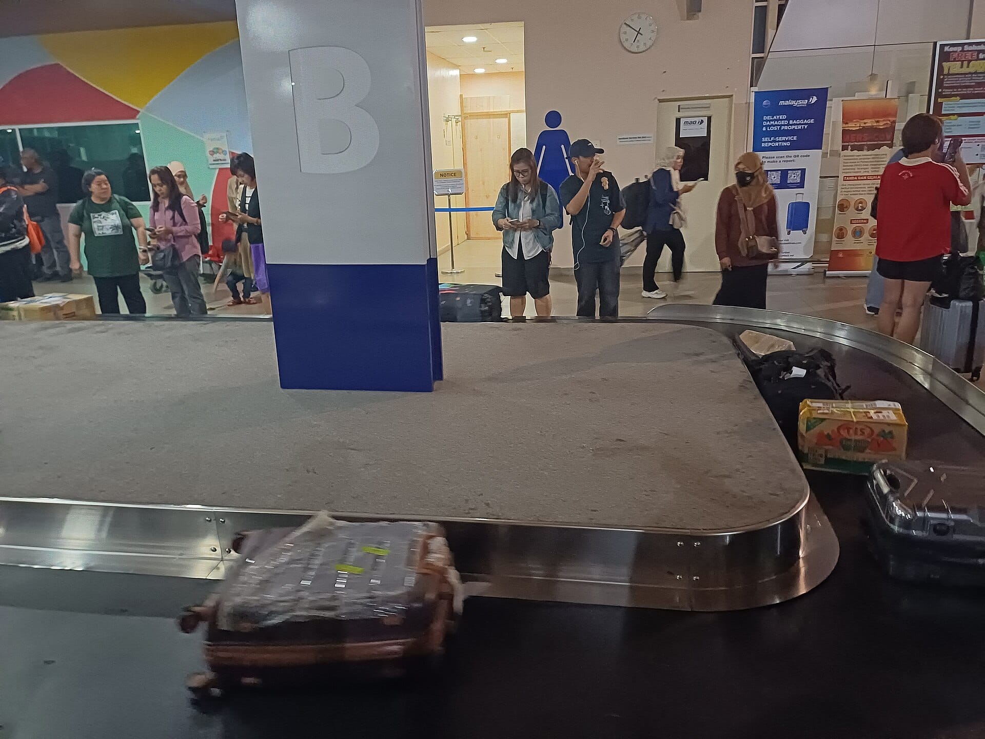 A suitcase on an airport baggage carousel
