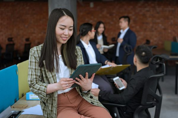 Women holding a tablet in office.