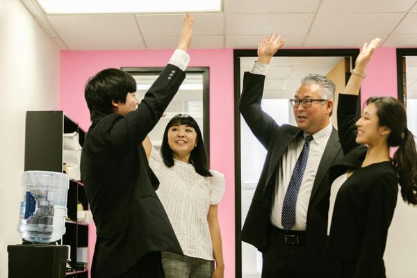 A group of people celebrating in the office.