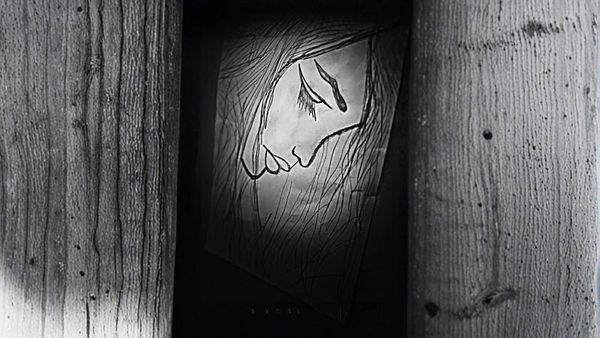 A black-and-white sketch of a sad woman’s face is partially visible through a narrow gap between wooden planks.