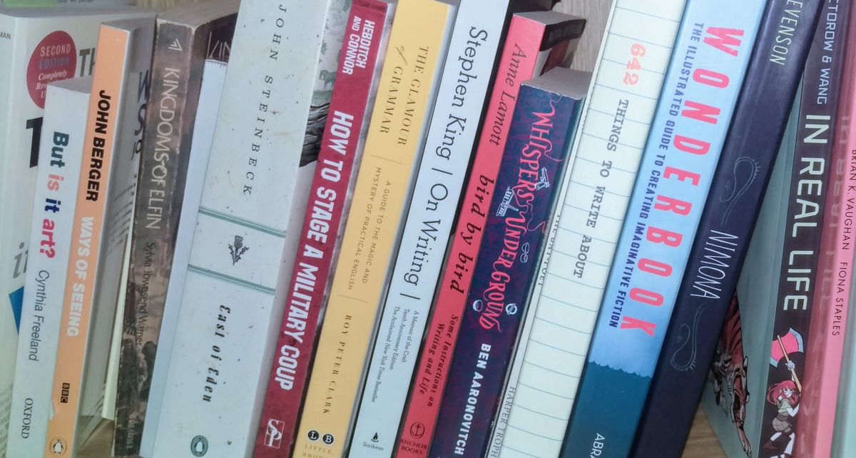 A shelf of writing books all slightly tilted to the right.