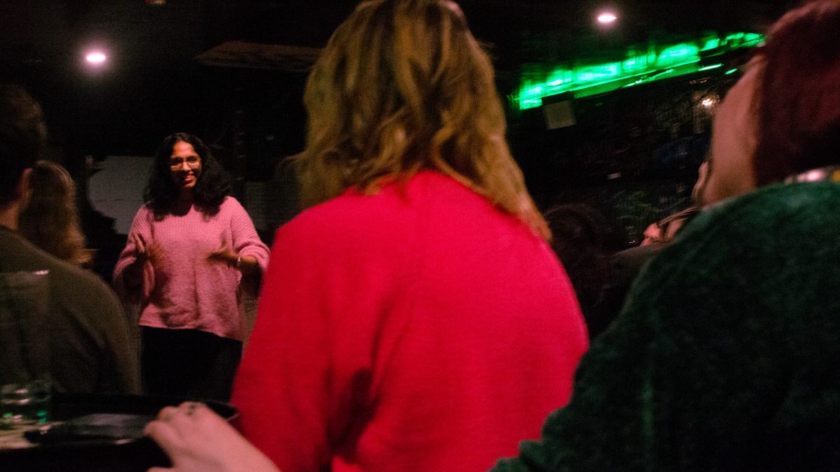 A woman sees herself through a lengthy stay in immigration limbo with help from open mics, group therapy