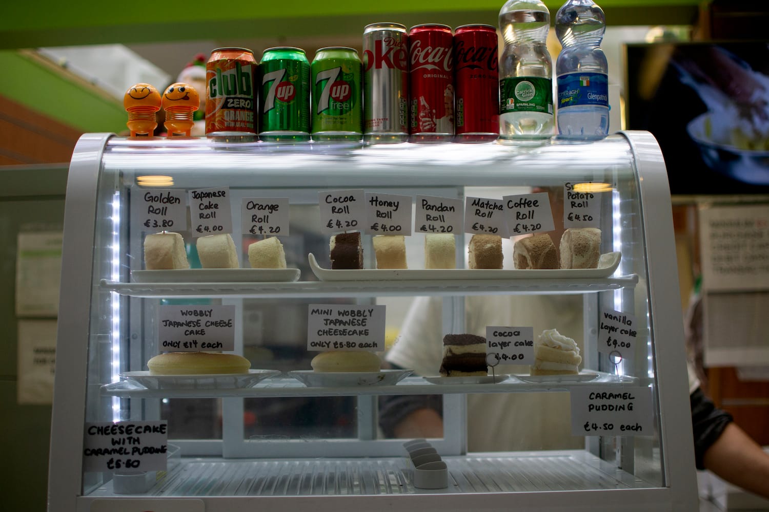 A display case with little cheese tarts in it.