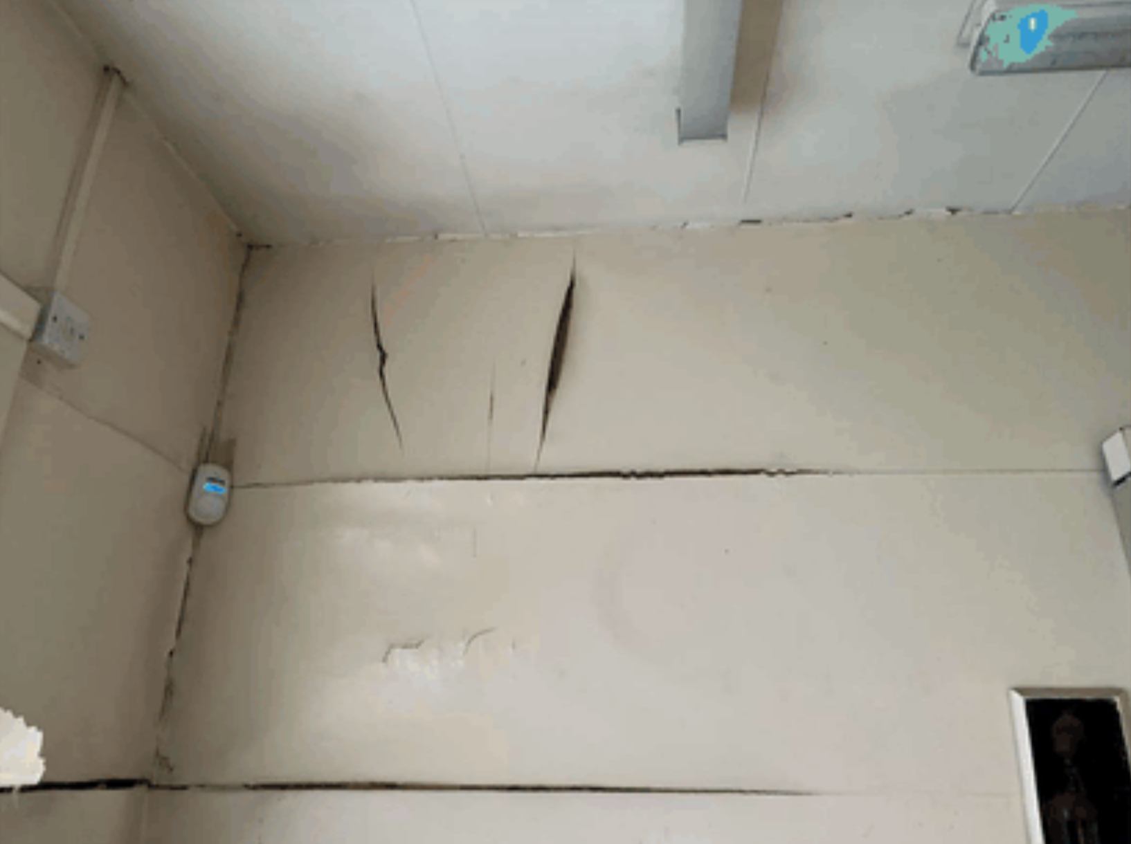 A peeling white wall.