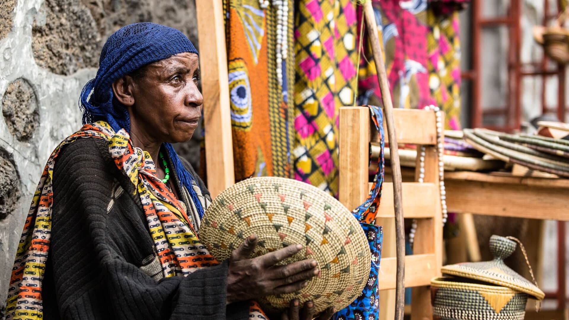 Woman selling traditional woven crafts at Kigali market, Rwanda