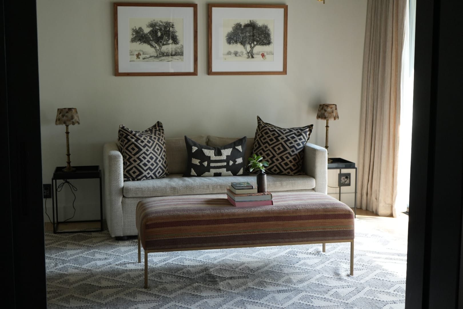 The Monwana suite interior. A sofa, low warm lighting, neutral textures.