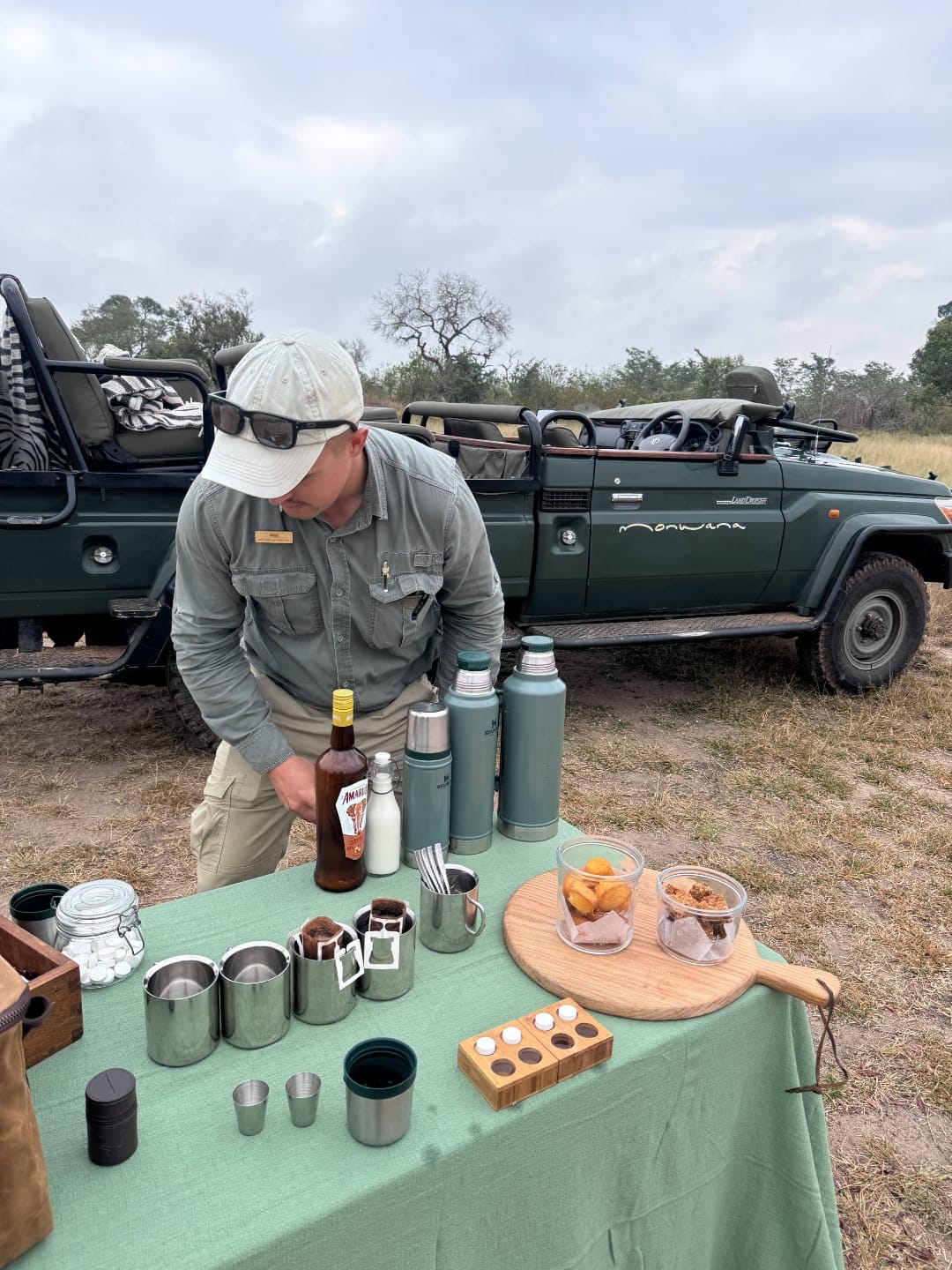 A bush coffee stop. A folding table laid out beside the Land Cruiser.