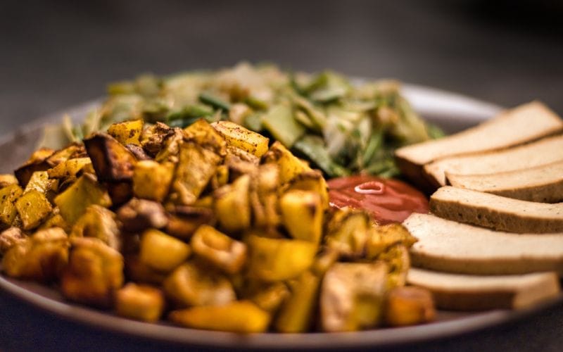 Colourful plant-based bowl with roasted vegetables and tahini at a Cape Town breakfast spot