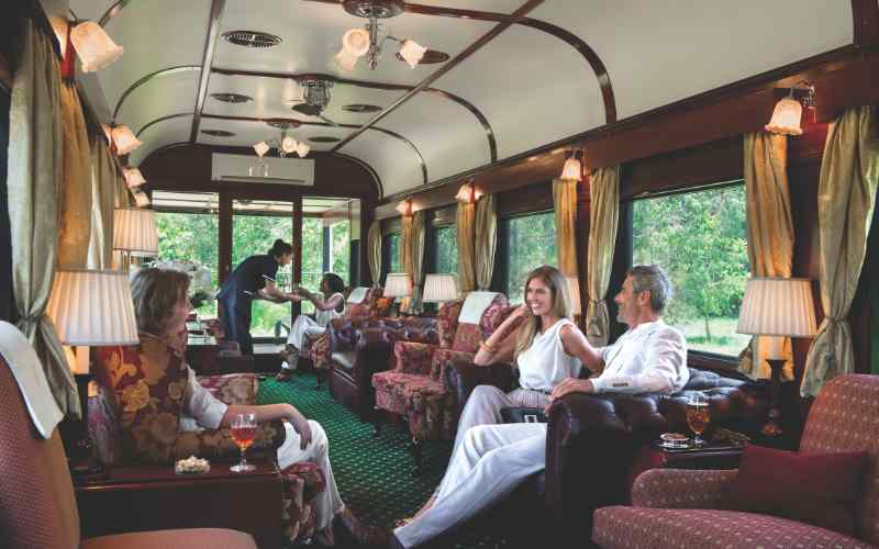 Rovos Rail dining car set for dinner with white linen and crystal glasses, South Africa