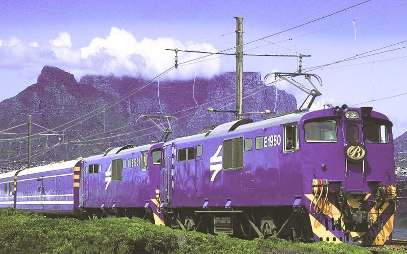 The Blue Train at a South African station, royal blue coaches in morning light
