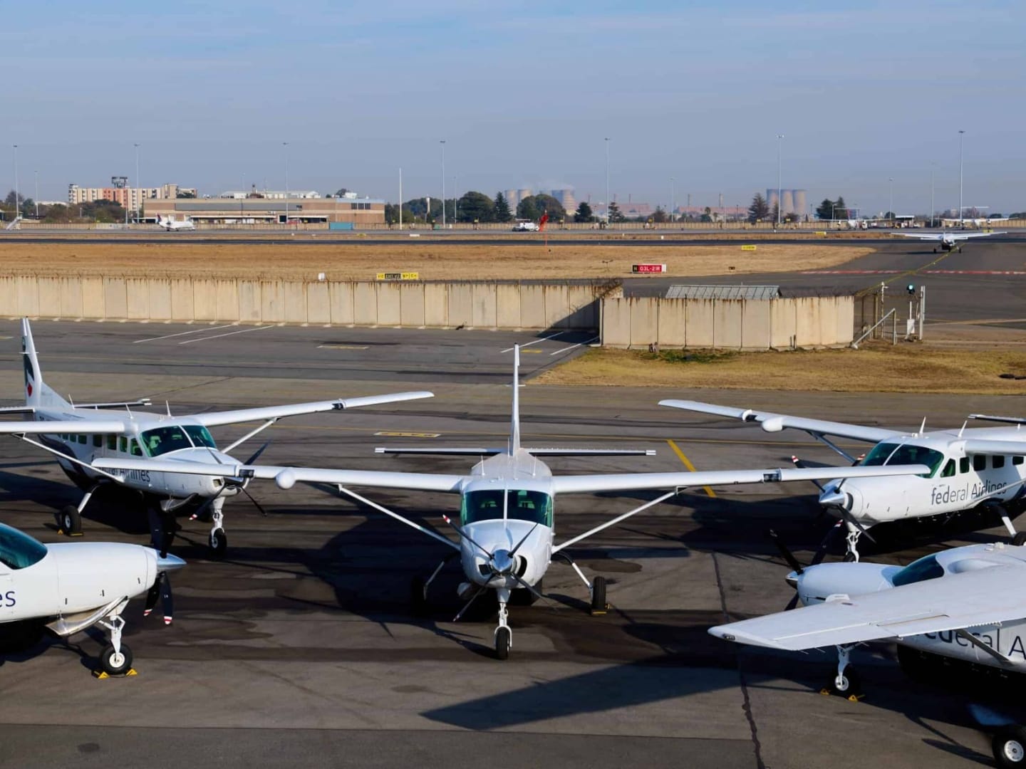 A fleet of Federal Airlines Cessna Caravan light aircraft parked on the apron at a Johannesburg airfield, the small turboprops that fly safari guests from the city to bush airstrips across South Africa