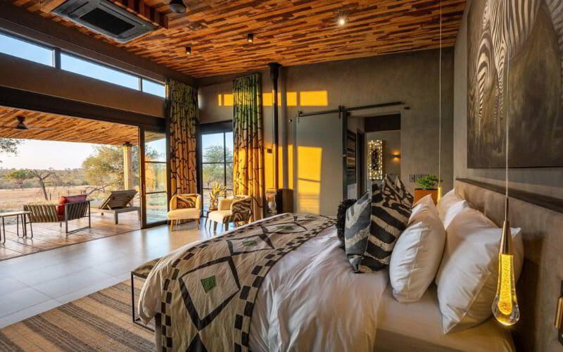 Luxury safari suite interior opening onto a private deck over the bush
