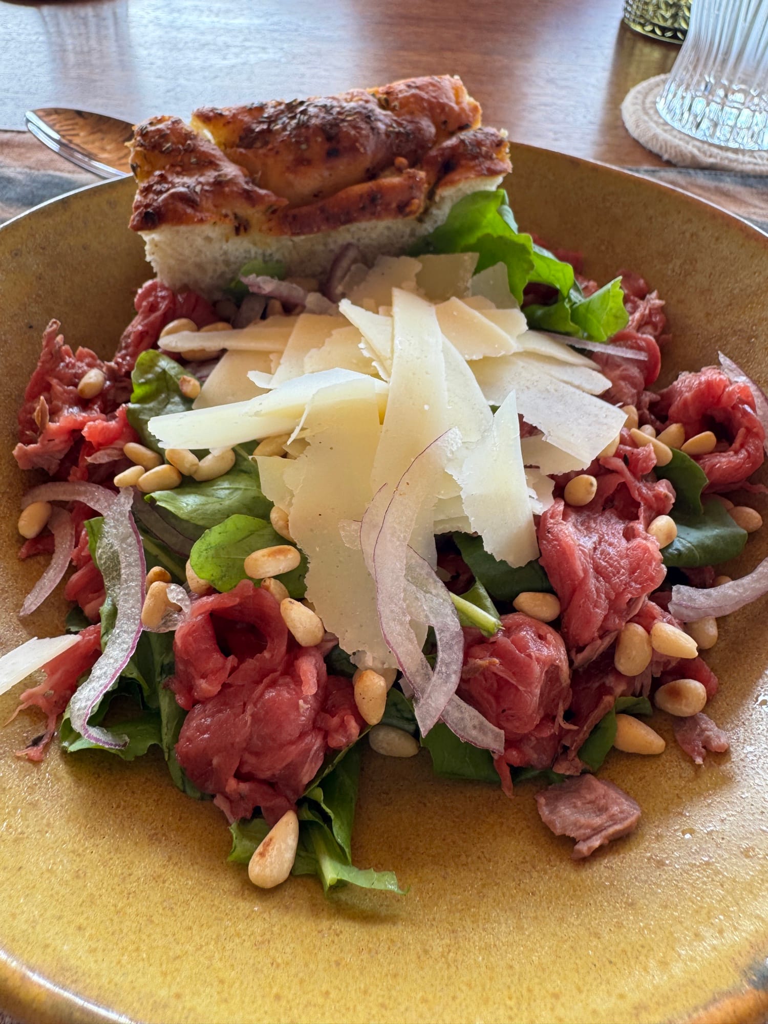 Beef carpaccio with shaved parmesan, pine nuts and focaccia at a luxury safari lodge