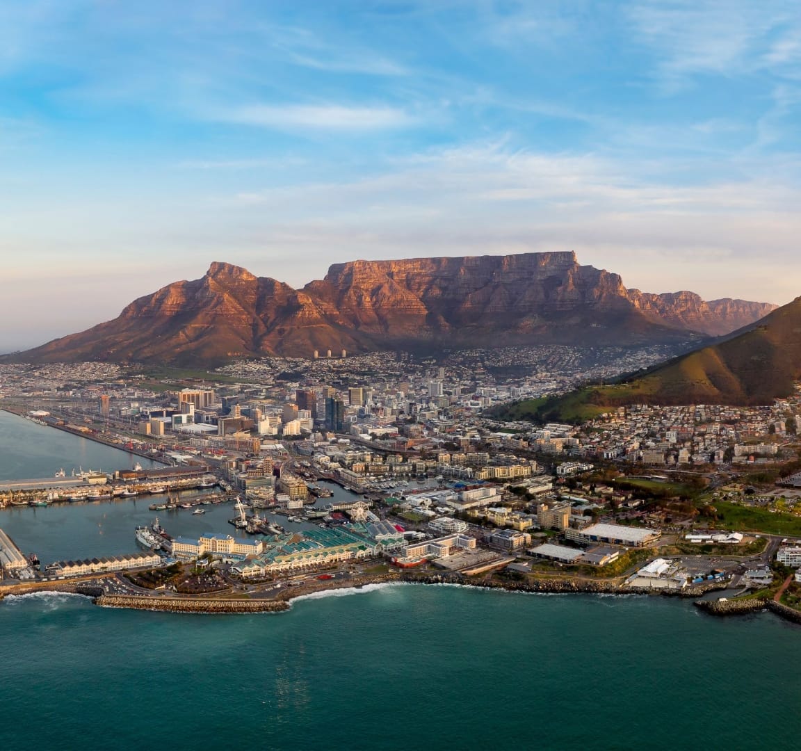 Aerial view of Cape Town with Table Mountain catching late light and the V&A Waterfront in the foreground