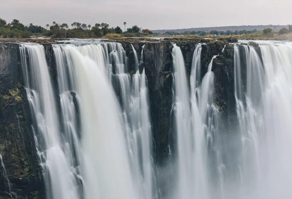 Long-exposure of Victoria Falls on the Zimbabwean side, sheets of water dropping into the gorge