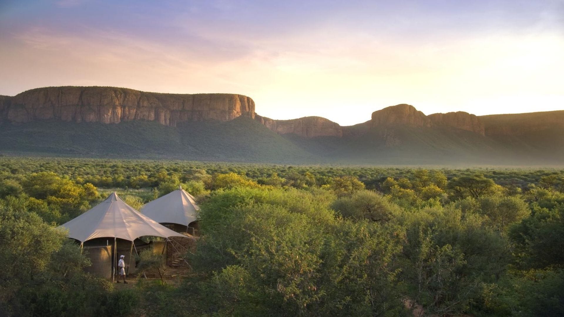 A tented suite at Marataba in the cliffs of the Marakele in South Africa, dusk light over the bush