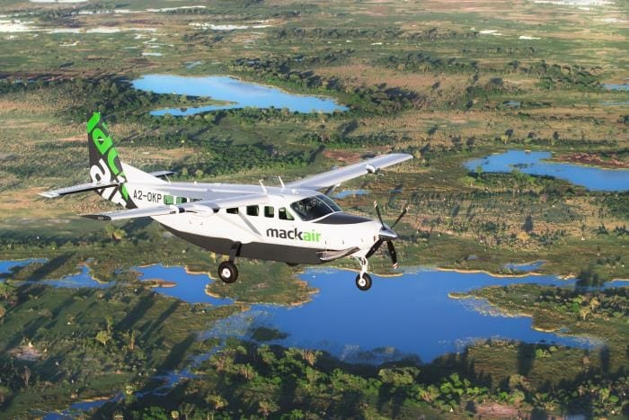 A Mack Air Cessna Caravan banks low over the Okavango Delta, a mosaic of channels, islands and floodplain unfurling beneath the wing