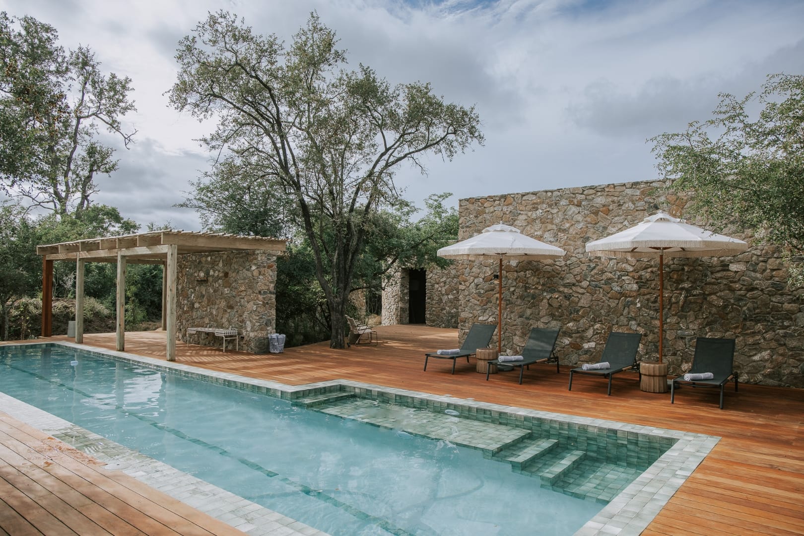 Pool and loungers at Saseka set against the surrounding bushveld