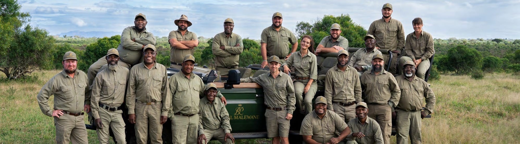 Royal Malewane's guiding team of guides and trackers gathered around a game-drive vehicle in the Greater Kruger.