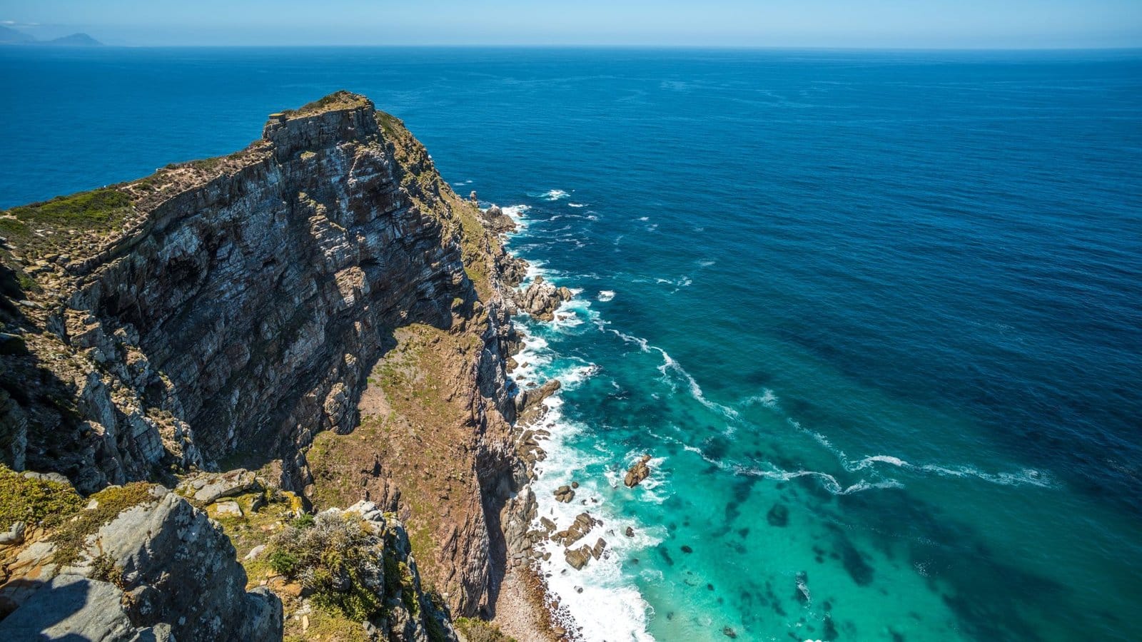 Sea cliffs at Cape Point dropping to turquoise water and the open ocean beyond