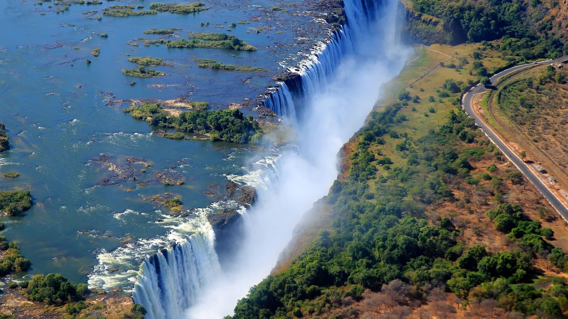 Aerial view of Victoria Falls plunging into its gorge, with the Zambezi above
