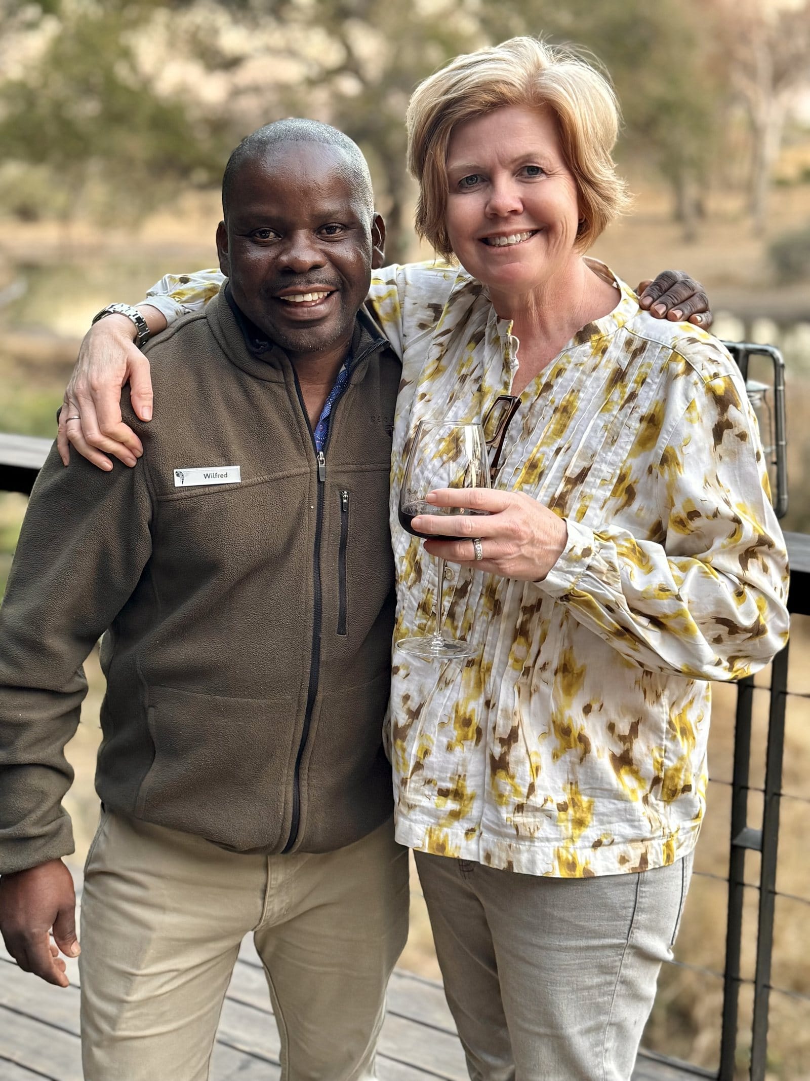 Vikki Jackson and Wilfred, Serondella's butler, arms around shoulders, on the viewing deck