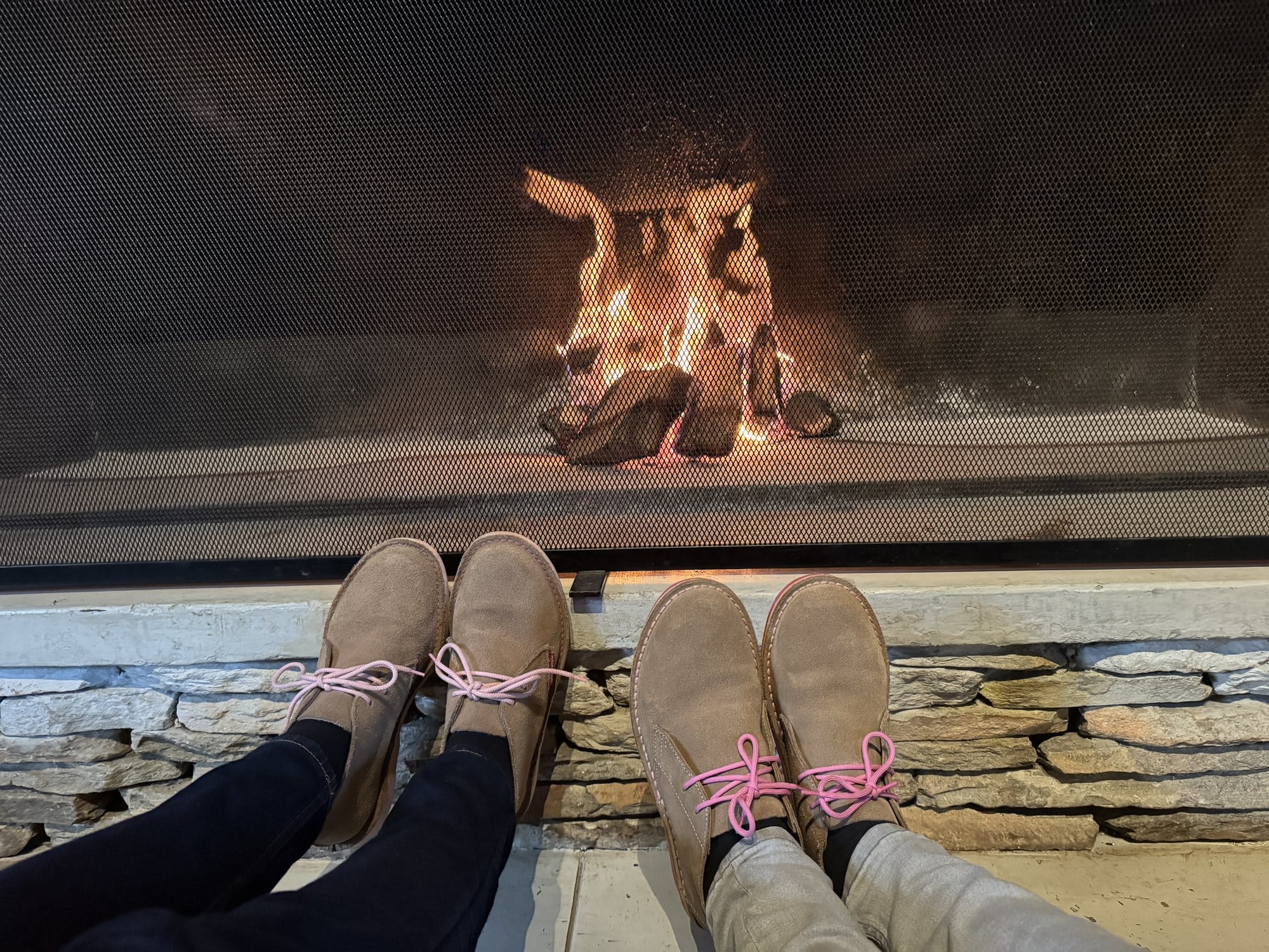 Two pairs of boots warming in front of Serondella's stone fireplace