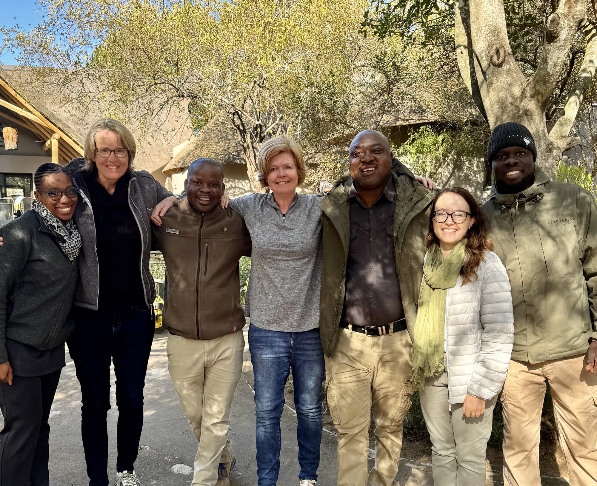 Vikki Jackson with six members of the Serondella team outside the lodge