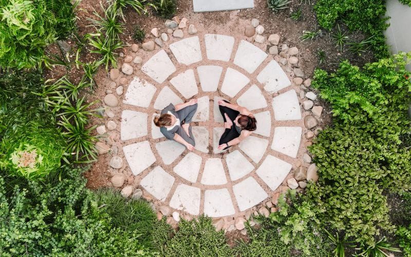 Two women meditating on their wellness safari