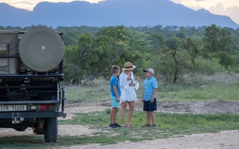 A family stops for sundowners on their safari