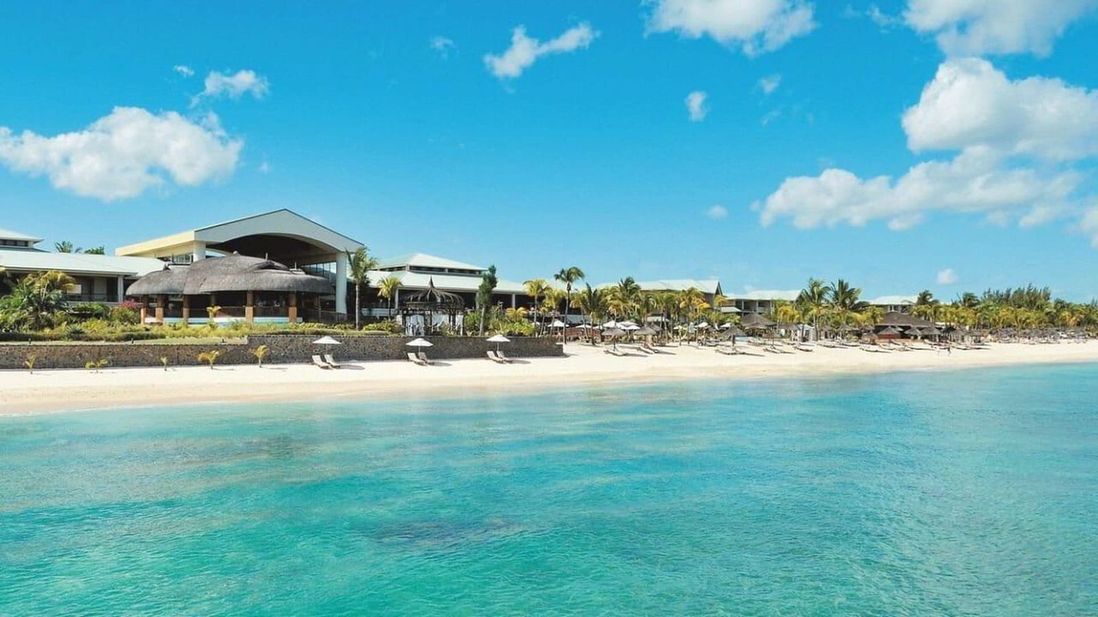 Tropical beach villa with white sand and turquoise water on an Indian Ocean island