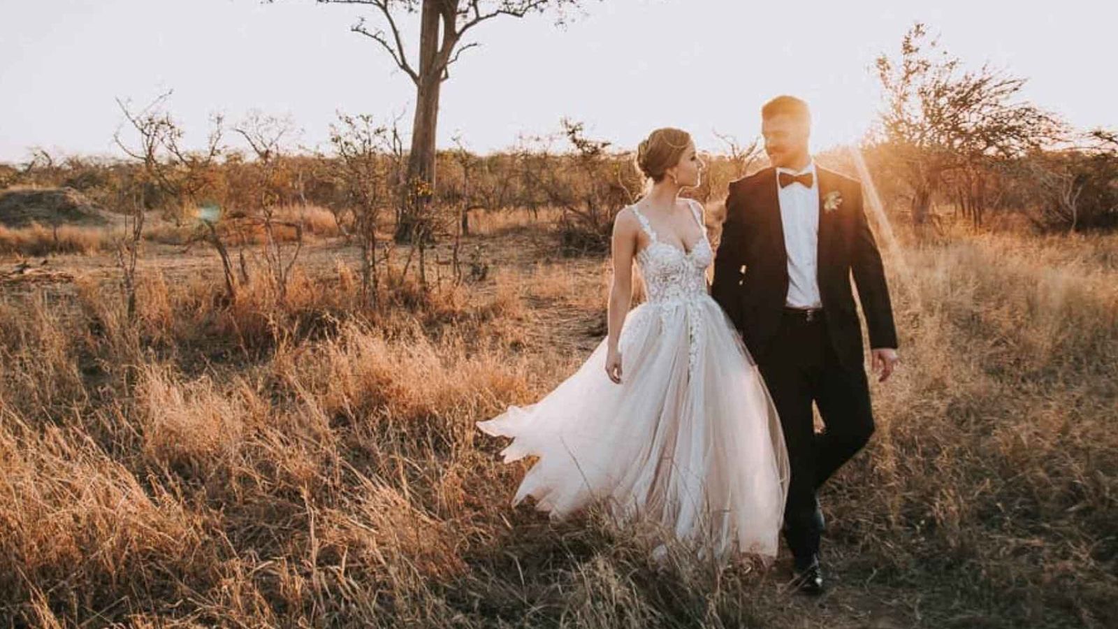 Outdoor wedding ceremony in the African bush at sunset under a tree