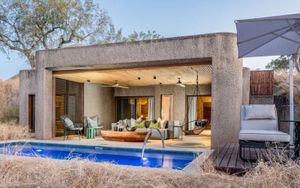 Luxury safari lodge in Sabi Sand with a private plunge pool and open-plan living area looking out over dry bushveld