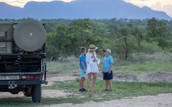 A family stops for sundowners on their safari