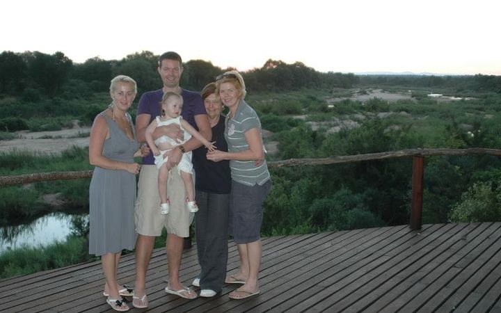 A family watching elephant on a game drive at golden hour in the South African bush