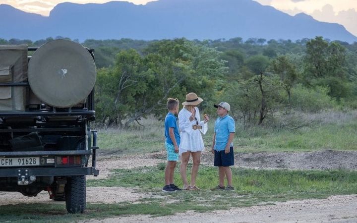 A family stops for sundowners on their safari