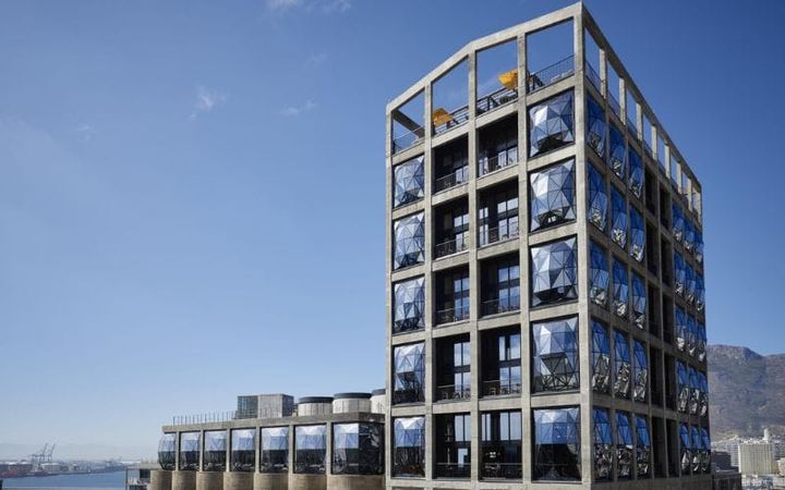 The Silo Hotel exterior on Cape Town's V&A Waterfront, its bulging pillowed glass windows catching the late afternoon light
