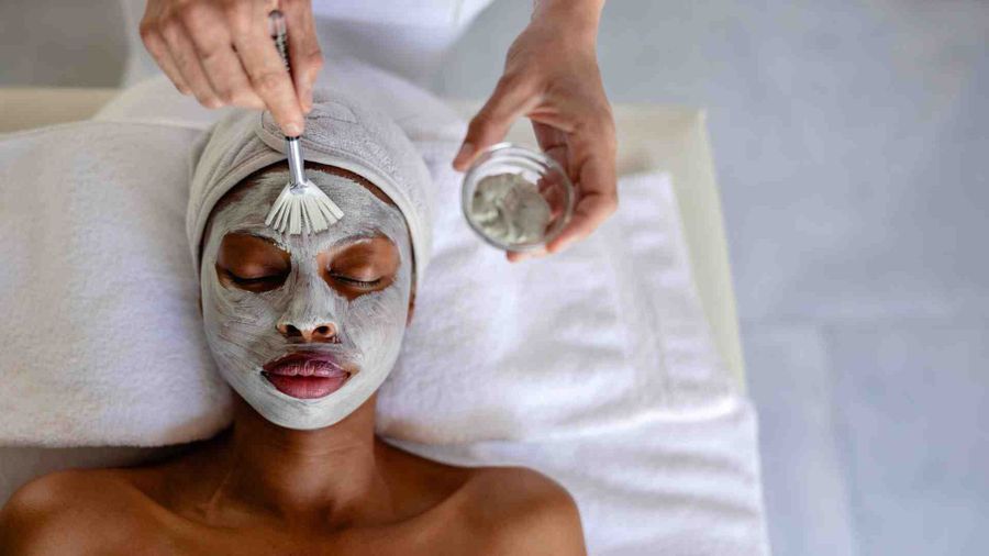 Spa treatment during a luxury safari in South Africa, with guest enjoying a facial at a private lodge in a game reserve.