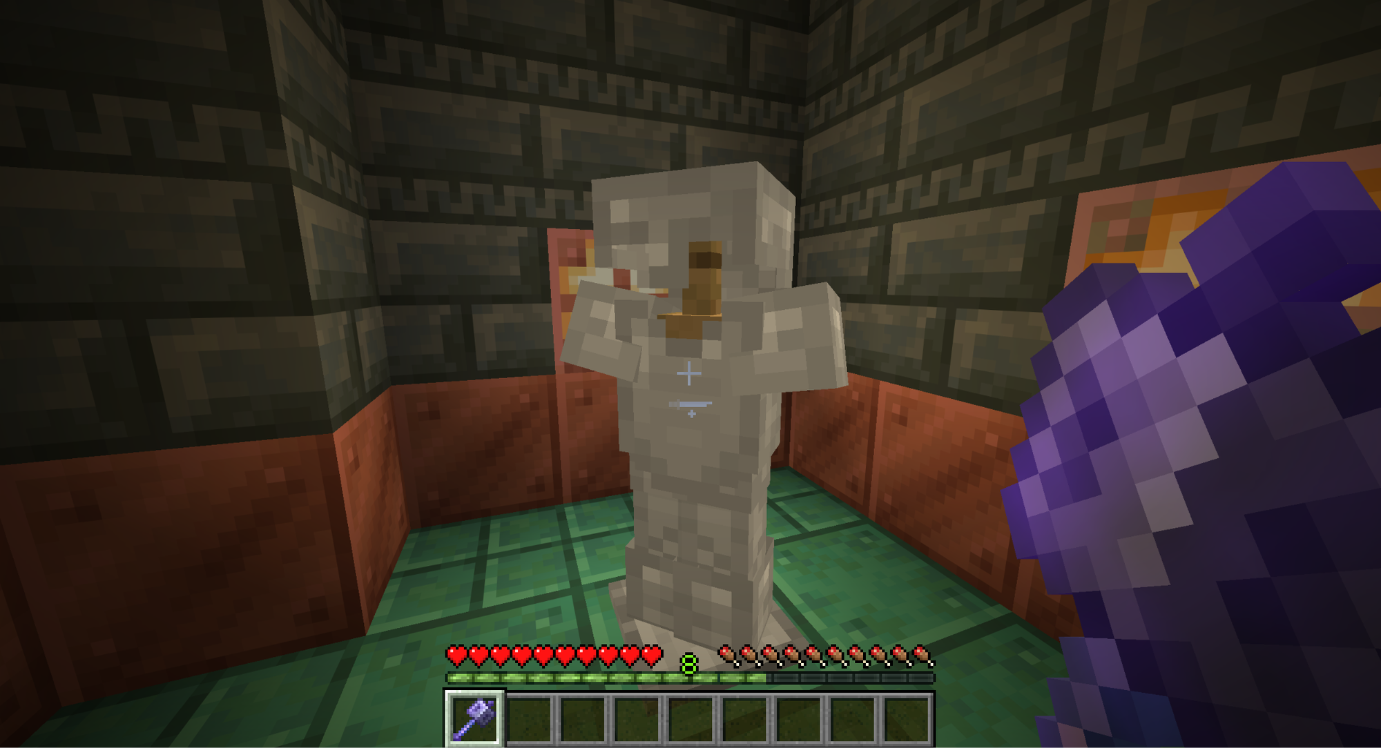 A Minecraft screenshot of the player holding an enchanted mace at an armor stand holding Iron Armor.