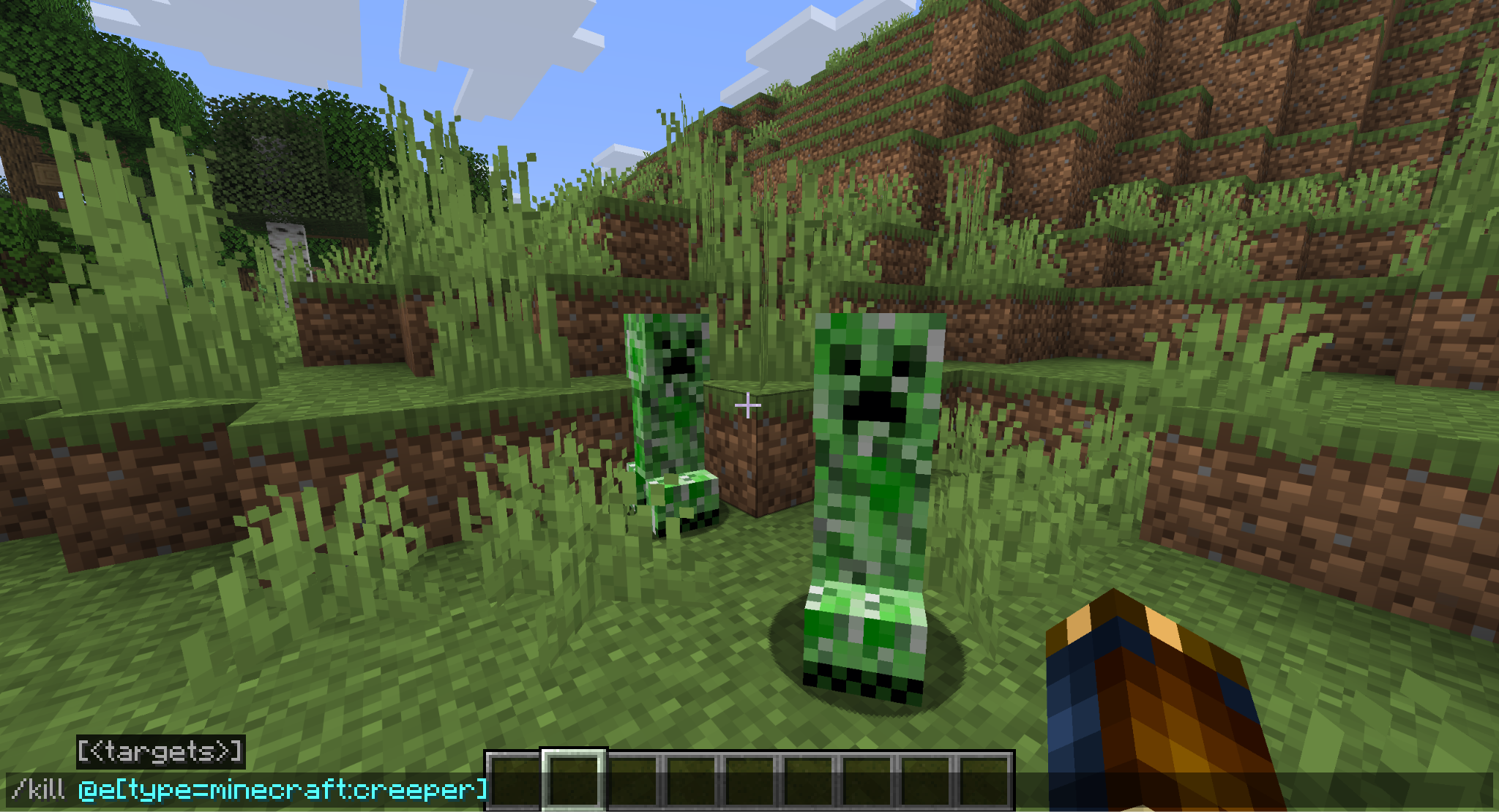 A Minecraft screenshot of two creepers, a kill command is typed into the chat.