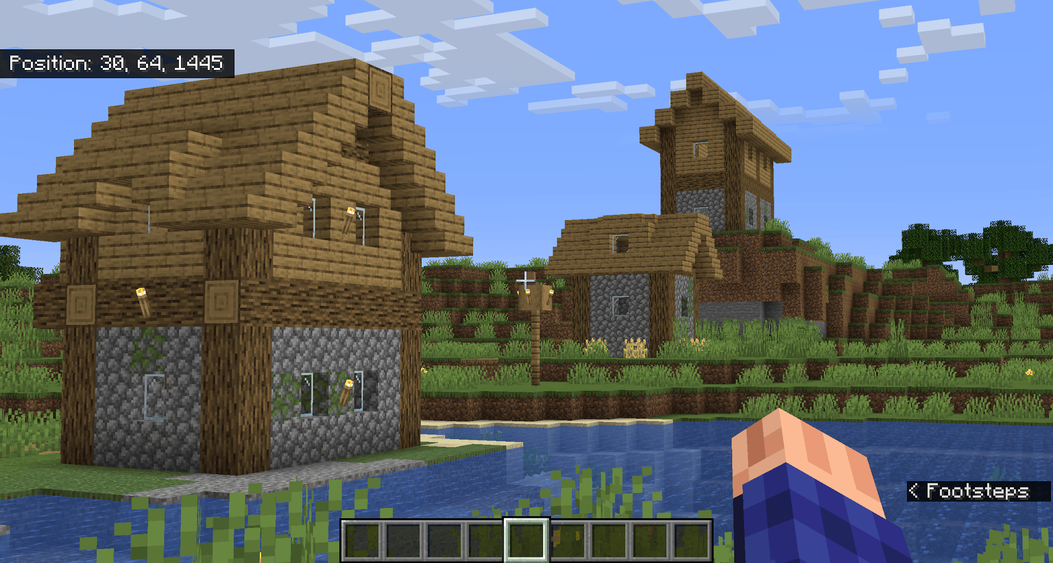 Minecraft Bedrock coordinate display showing position near a village.