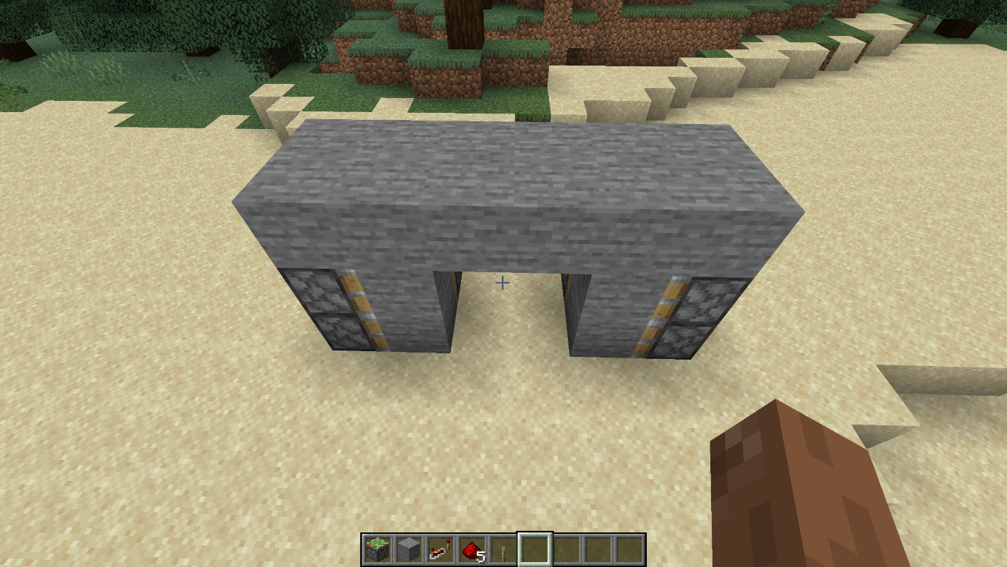 A compact 2x2 hidden piston door mechanism covered with a single layer of stone blocks in Minecraft.
