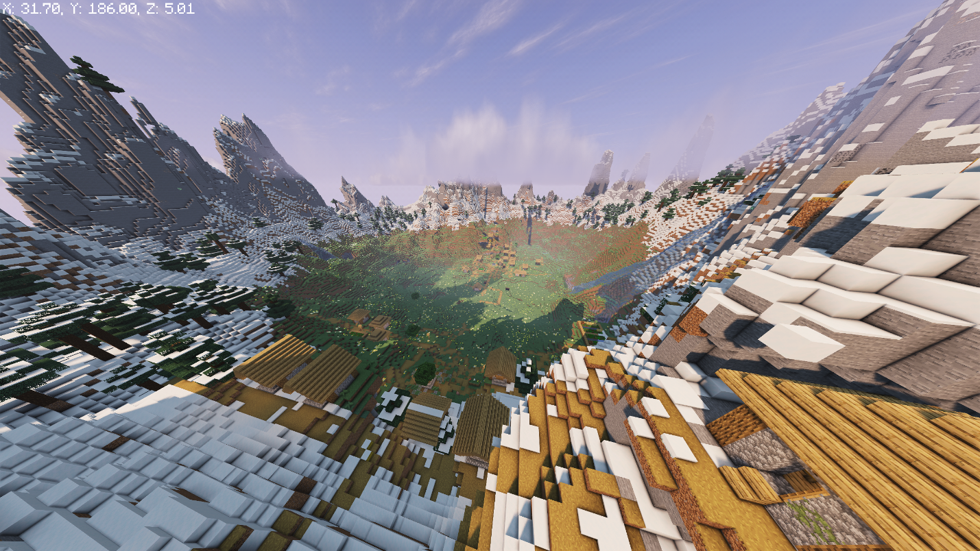 Frozen Peaks ringing a green valley, with a villages visible below.